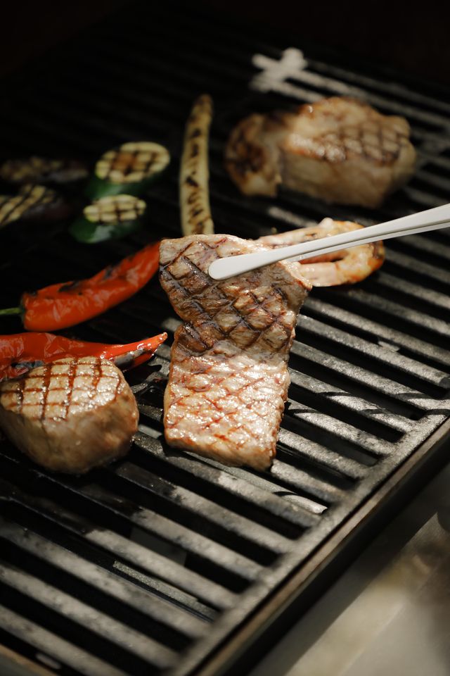 Enjoy a garden terrace barbecue surrounded by a forest of green maple leaves.