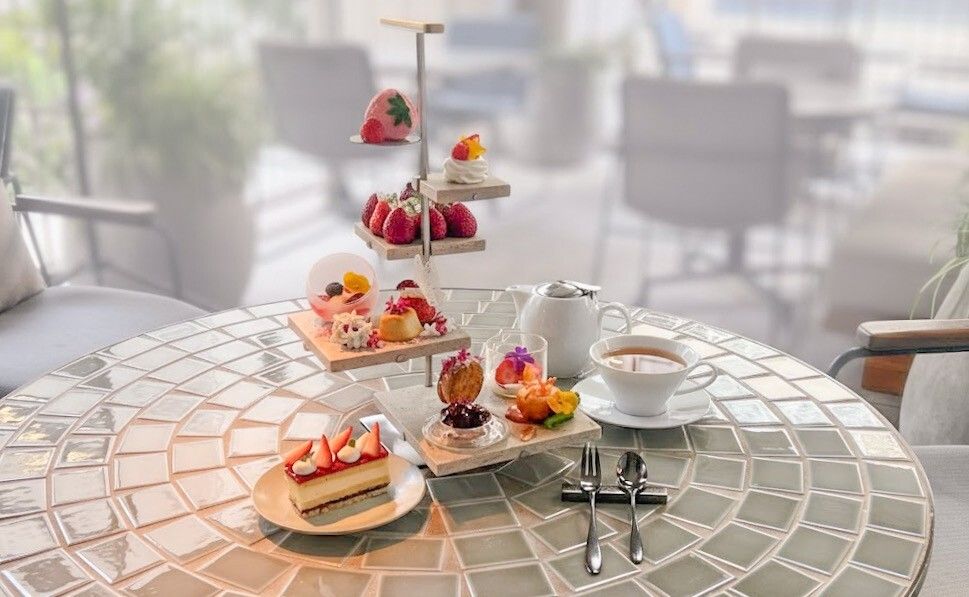 Strawberry afternoon tea with spring flowers fluttering about