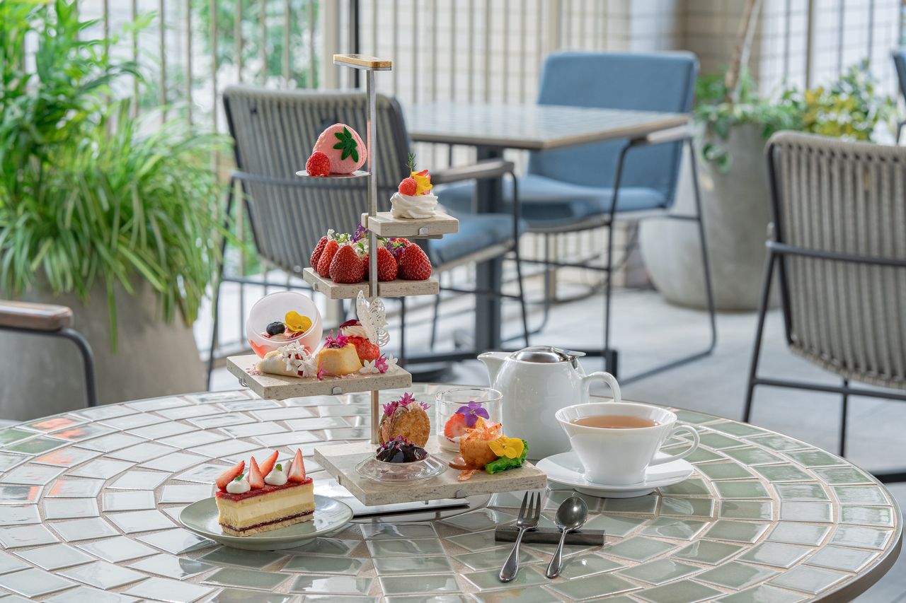 Strawberry afternoon tea with spring flowers fluttering about